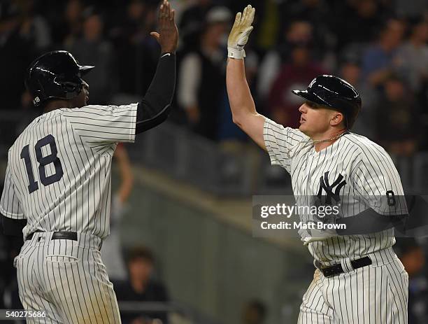 Didi Gregorius and Chris Parmelee of the New York Yankees celebrate after scoring on a two-run home run by Parmelee during the sixth inning of the...