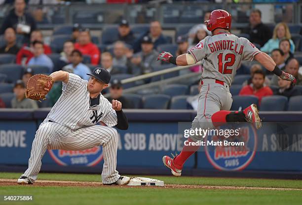 Chris Parmelee of the New York Yankees catches a forceout as Johnny Giavotella of the Los Angeles Angels of Anaheim runs during the third inning of...