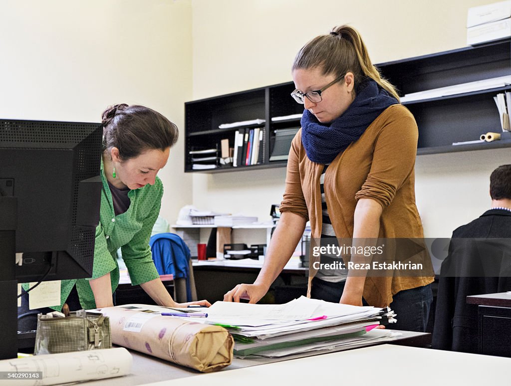 Coworkers in discussion at desk