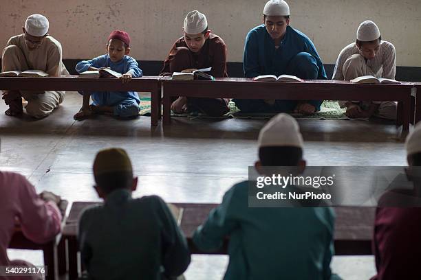 Students recite from the Quran at a madrasa in Old Dhaka during Ramadan in Dhaka, Bangladesh on June 14, 2016. Muslims around the world are observing...