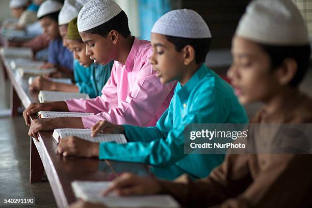 Students recite from the Quran at a madrasa in Old Dhaka during Ramadan in Dhaka, Bangladesh on June 14, 2016. Muslims around the world are observing...