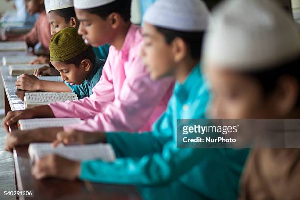 Students recite from the Quran at a madrasa in Old Dhaka during Ramadan in Dhaka, Bangladesh on June 14, 2016. Muslims around the world are observing...