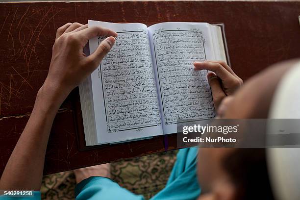 Students recite from the Quran at a madrasa in Old Dhaka during Ramadan in Dhaka, Bangladesh on June 14, 2016. Muslims around the world are observing...