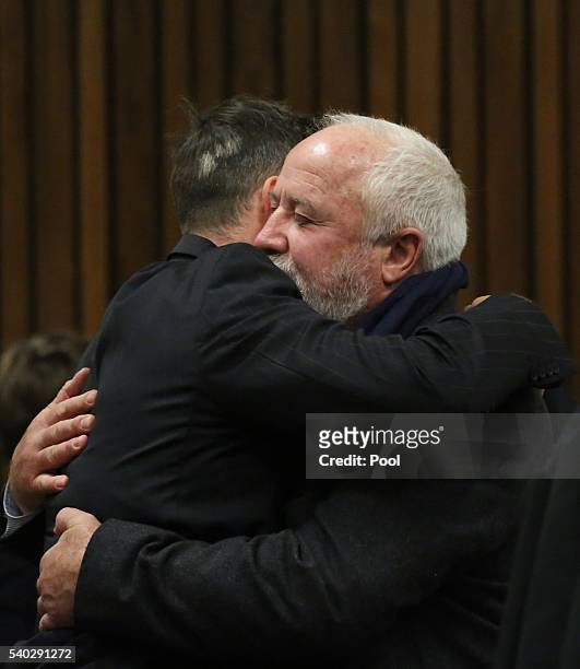Oscar Pistorius embraces his father, Henke Pistorius during the third day of Oscar's hearing for a resentence at Pretoria High Court on June 15, 2016...
