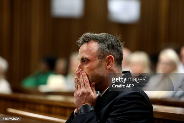 South African Paralympian Oscar Pistorius gestures during the third day of his hearing at the Pretoria High Court for sentencing procedures in his...