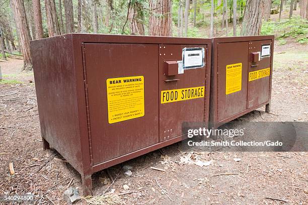 Bear safe food storage lockers for campers in Yosemite National Park, with signs warning campers not to leave food in their cars, Yosemite Valley,...