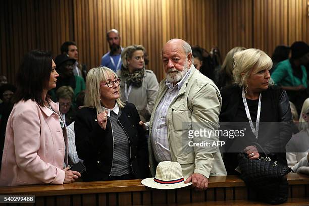 Reeva Steenkamp's father Barry Steenkamp and mother June Steenkamp stand with family members during the third day of the hearing of South African...