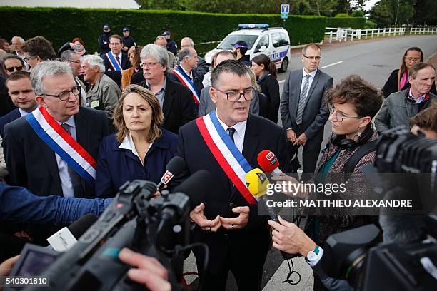 The Mayor of Magnanville, Michel Lebouc speaks to the press next to French Communist Party National Secretary Pierre Laurent on June 15 outside the...