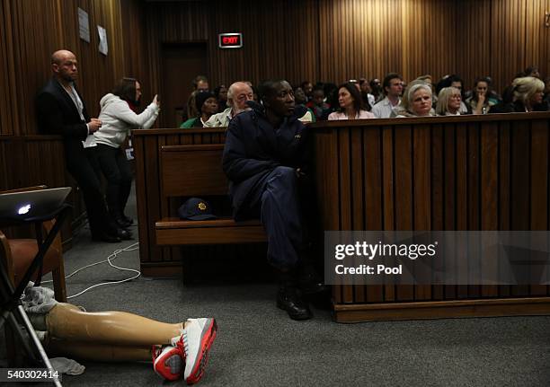 The legs of Oscar Pistorius are left on the ground as he walks across the courtroom without his prosthetic legs during the third day of Oscar's...