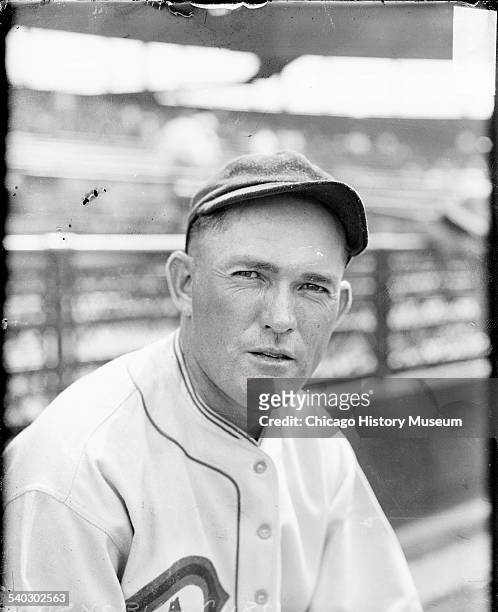 Baseball player Rogers Hornsby of the National League's Chicago Cubs, sitting in front of grandstands on the field at Wrigley Field, Chicago,...