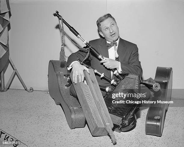 Studs Terkel at the Off Beat Room, located at 1037 Granville Avenue, sitting with an autoharp, Highland bagpipe and the dulcimer, Chicago, Illinois,...