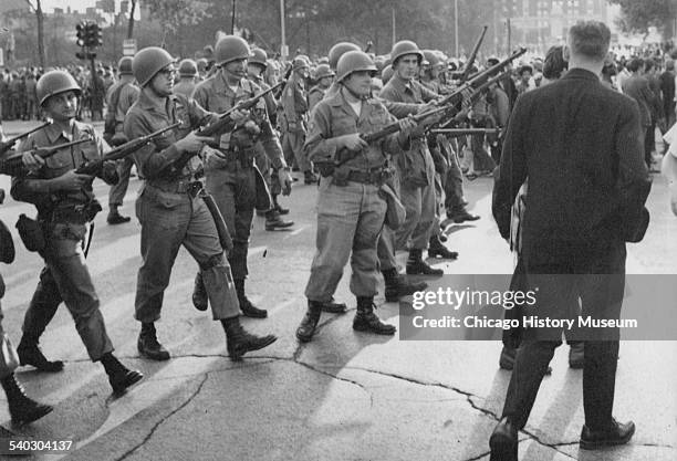 View of National Guardsmen in the street holding rifles during the 1968 Democratic National Convention demonstrations, Chicago, Illinois, August...