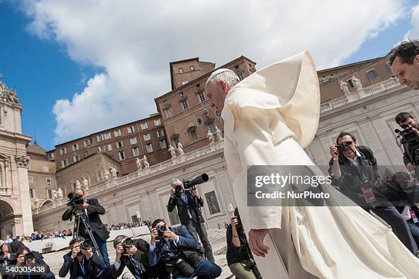 Pope Francis' mantle is blown by a gust of wind during his weekly general audience in St. Peter's Square at the Vatican, Wednesday, June 15, 2016