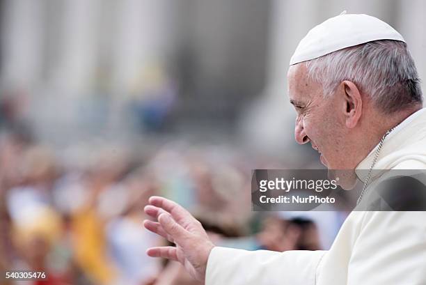 Pope Francis salutes the faithful as he arrives for his weekly general audience in St. Peter's Square at the Vatican, Wednesday, June 15, 2016.