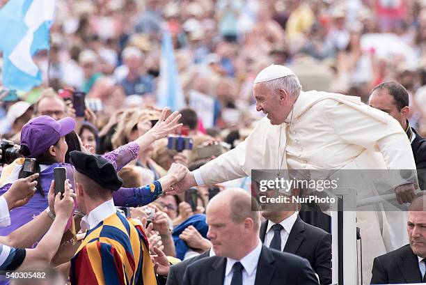 Pope Francis salutes the faithful as he arrives for his weekly general audience in St. Peter's Square at the Vatican, Wednesday, June 15, 2016.