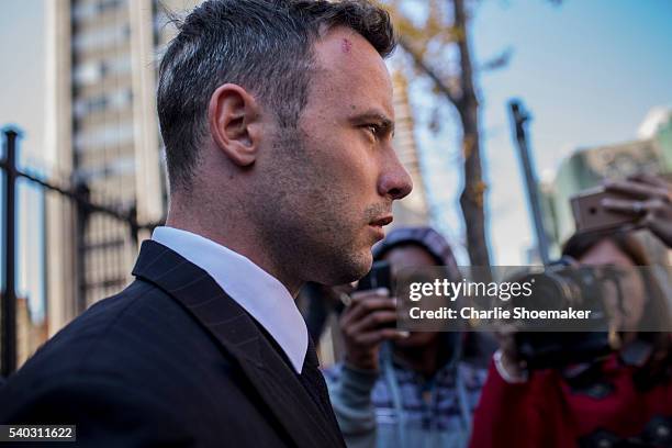 Oscar Pistorius leaves the North Gauteng High Court for lunch after removing his removing prosthetic legs earlier by his defense counsel Barry Roux...