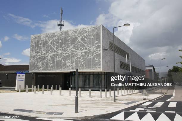 French flag flies half-mast outside the police station in Les Mureaux, on June 15 where a French police officer, who was killed on the night of June...