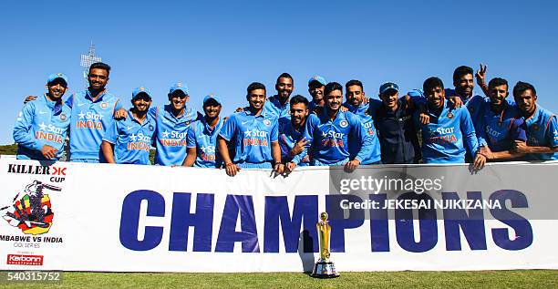 India's players pose with the ODI series trophy after winning the third and final ODI cricket match between India and Zimbabwe at the Harare Sports...