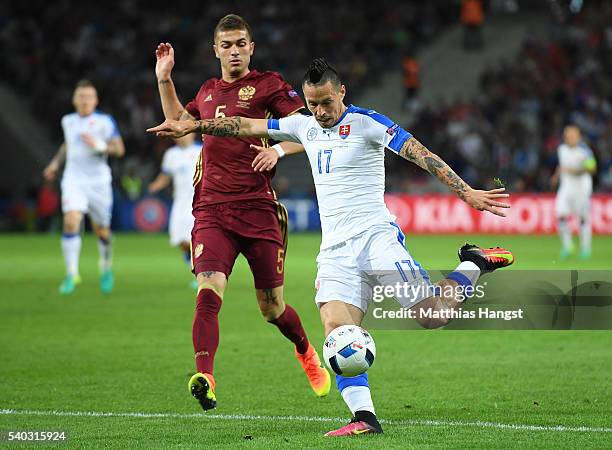 Roman Neustädter of Russia closes down Marek Hamsik of Slovakia during the UEFA EURO 2016 Group B match between Russia and Slovakia at Stade...