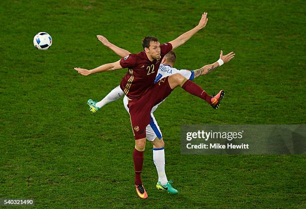 Jan Durica of Slovakia and Artem Dzyuba of Russia batlle for possesion during the UEFA EURO 2016 Group B match between Russia and Slovakia at Stade...