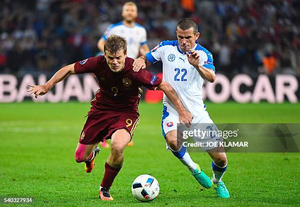 Russia's forward Alexander Kokorin vies with Slovakia's midfielder Viktor Pecovsky during the Euro 2016 group B football match between Russia and...