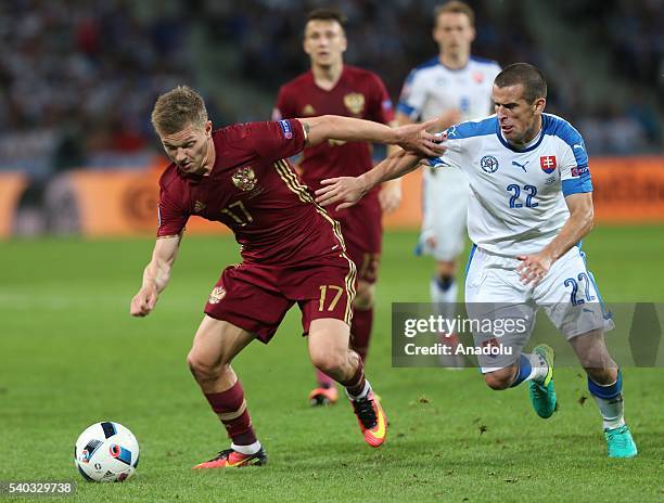 Oleg Shatov of Russia in action against Viktor Pecovsky of Slovakia during the UEFA Euro 2016 Group B match between Russia and Slovakia at the Stade...