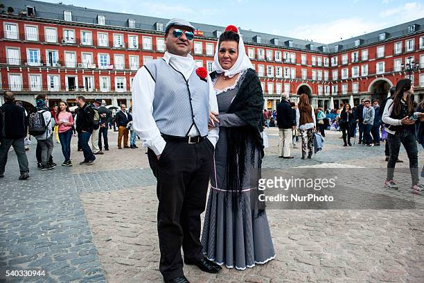Couple in the typical suit of &quot;chulapo&quot; Madrid's Plaza Mayor perches on the occasion of the festival of San Isidro