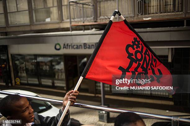 South African students from Chief Albert Luthuli Primary and High School in Daveyton hold a flag reading "I am constitution" as they take a ride on a...