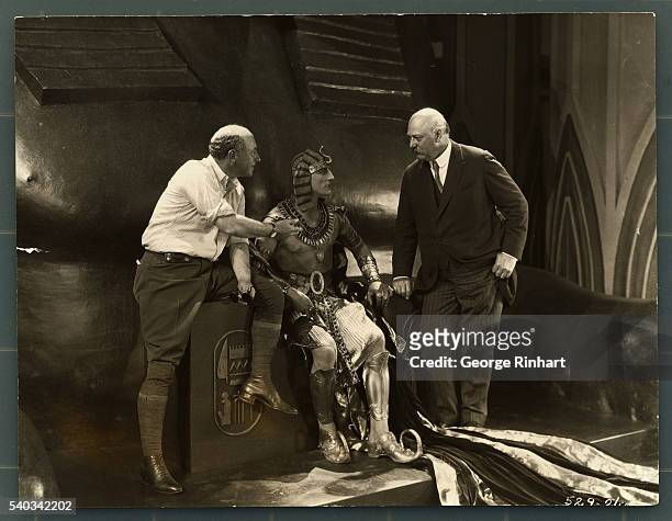 Director Cecil B. Demille talking to actor Charles De Roche on the set of the film "The Ten Commandments."
