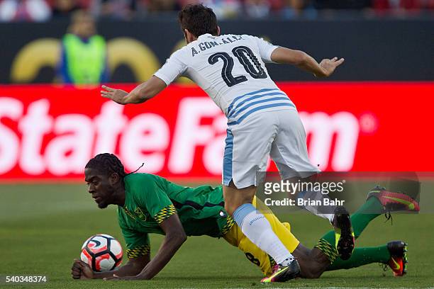 Clayton Donaldson of Jamaica takes a fall against Alvaro Gonzalez of Uruguay in the first half during a group C match at Levi's Stadium as part of...