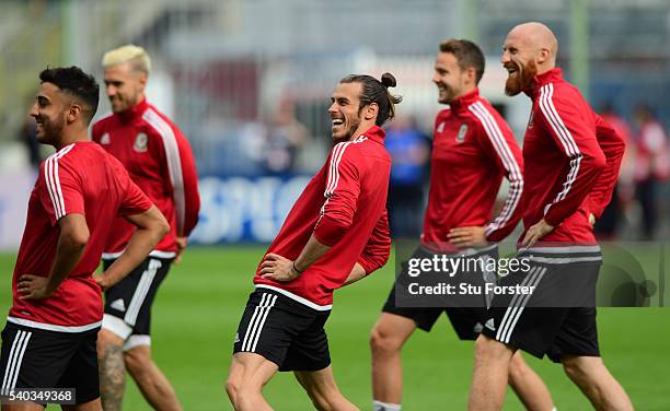 Wales player Gareth Bale shares a joke with team mates during Wales training ahead of their Euro 2016 match against England at Stade Bollaert-Delelis...