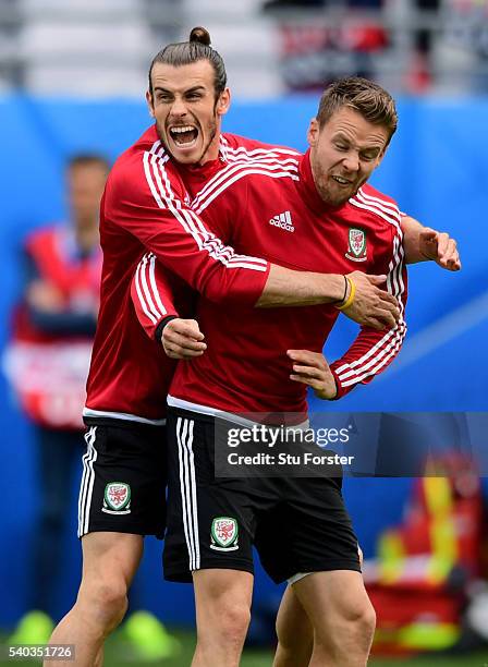 Wales player Gareth Bale shares a joke with Chris Gunter during Wales training ahead of their Euro 2016 match against England at Stade...