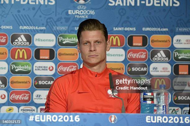 In this handout image provided by UEFA Poland player Lukasz Piszczek addresses the press during a Poland press conference on June 15, 2016 in Paris,...