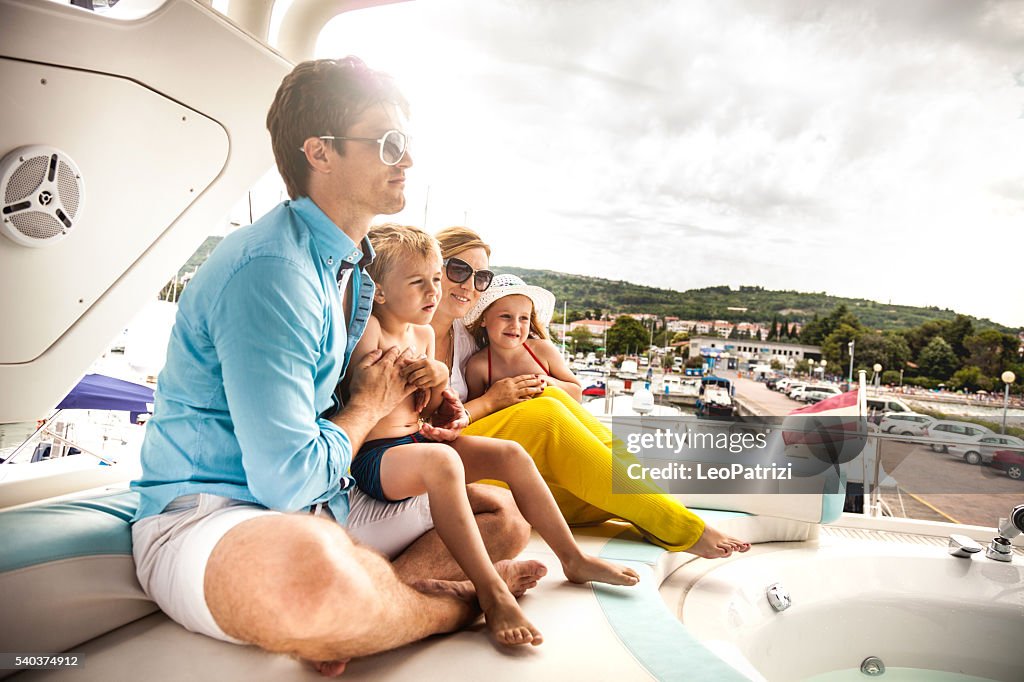 Family together on a boat in summer vacation