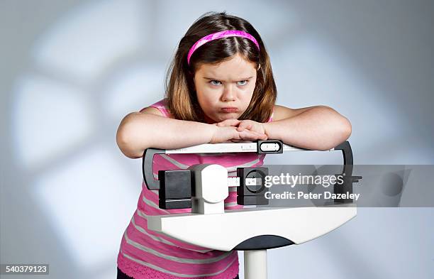 disappointed overweight girl on scales - overweight stock pictures, royalty-free photos & images