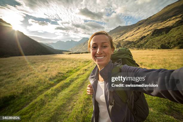 self portrait of female hiking in the valley at sunrise - tourist selfie stock pictures, royalty-free photos & images