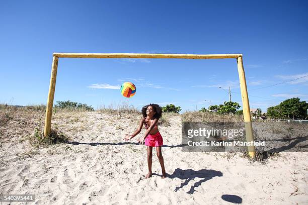 black girl playing with a football on the sand - brazilian playing football stock pictures, royalty-free photos & images