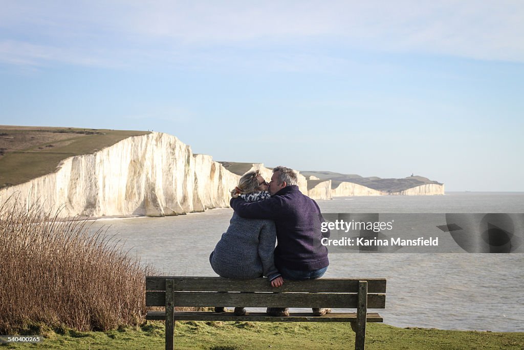 Couple sitting on the bench looking at the view