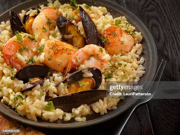 seafood risotto with fresh parsley - risotto stock pictures, royalty-free photos & images