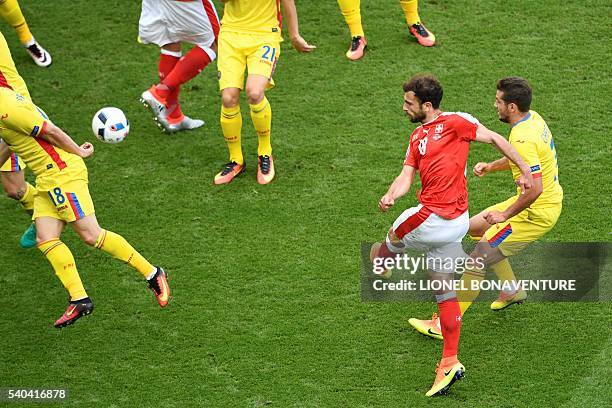 Switzerland's forward Admir Mehmedi shoots to score a goal during the Euro 2016 group A football match between Romania and Switzerland at the Parc...
