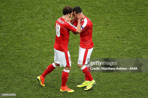 Admir Mehmedi of Switzerland celebrates after scoring a goal to make the score 1-1 during the UEFA EURO 2016 Group A match between Romania and...