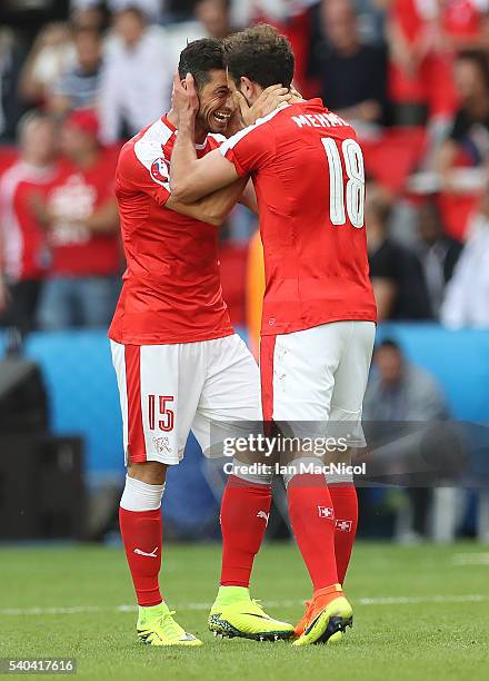 Admir Mehmedi of Switzerland celebrates scoring with Blerim Dzemaili of Switzerland during the UEFA EURO 2016 Group A match between Romania and...