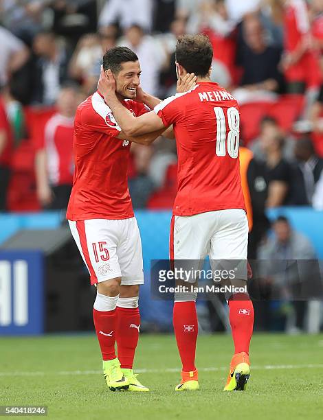 Admir Mehmedi of Switzerland celebrates scoring with Blerim Dzemaili of Switzerland during the UEFA EURO 2016 Group A match between Romania and...