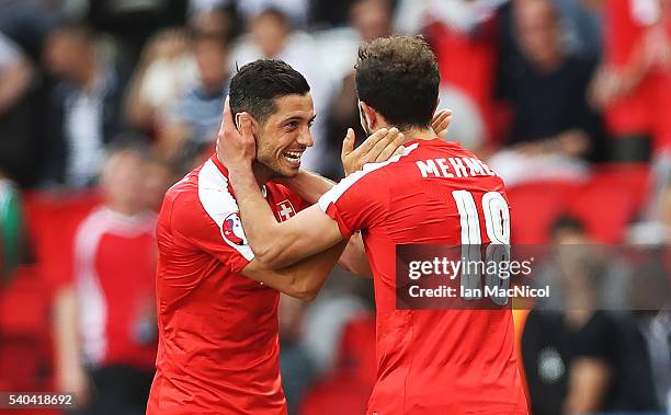 Admir Mehmedi of Switzerland celebrates scoring with Blerim Dzemaili of Switzerland during the UEFA EURO 2016 Group A match between Romania and...