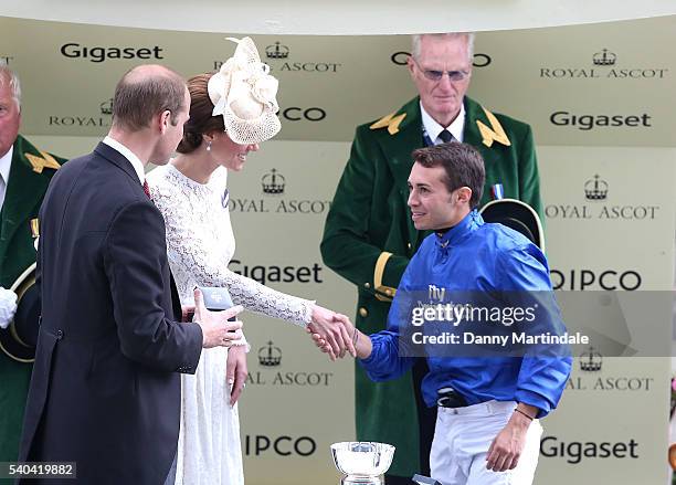 Catherine, Duchess of Cambridge and Prince William, Duke of Cambridge give the winning jocky Mickael Barzalona his cup for winning the Duke of...