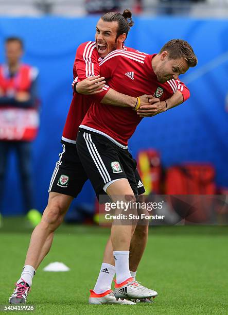 Wales player Gareth Bale shares a joke with Chris Gunter during Wales training ahead of their Euro 2016 match against England at Stade...