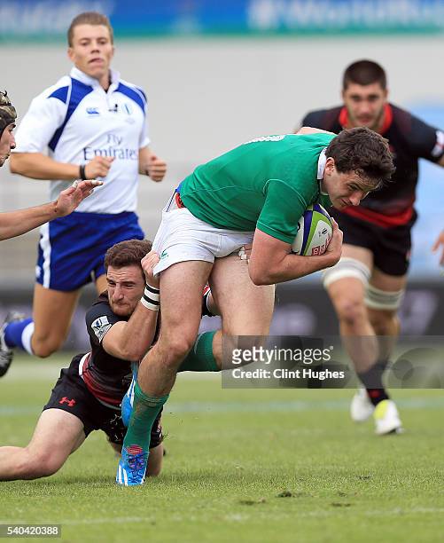 Hugo Keenan of Ireland is tackled by Vasil Lobzhanidze of Georgia during the World Rugby U20 Championship match at the The Academy Stadium on June...