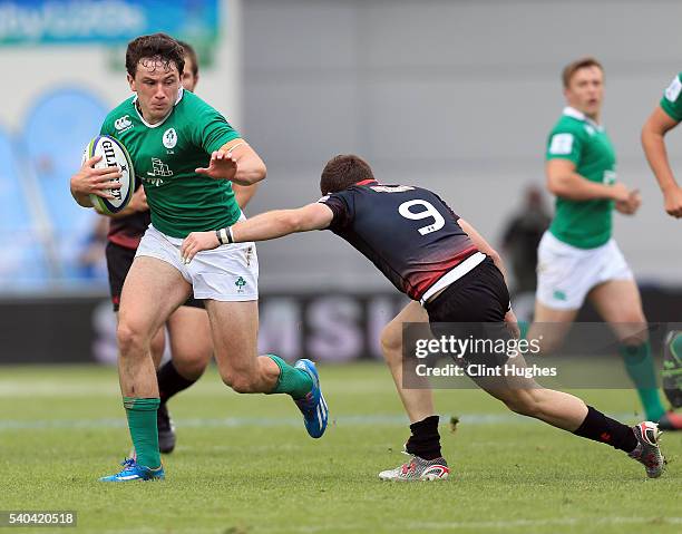 Hugo Keenan of Ireland is tackled by Vasil Lobzhanidze of Georgia during the World Rugby U20 Championship match at the The Academy Stadium on June...