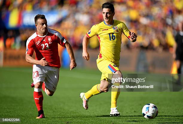 Xherdan Shaqiri of Switzerland chases down Steliano Filip of Romania during the UEFA EURO 2016 Group A match between Romania and Switzerland at Parc...