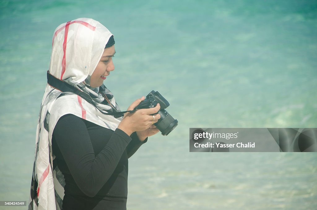 Woman looking at camera on a beach